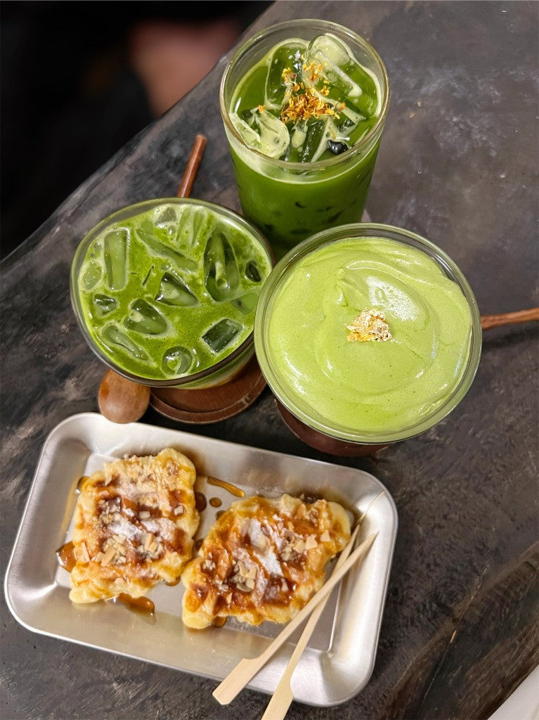 Iced matcha drinks and matcha desserts on a cafe table