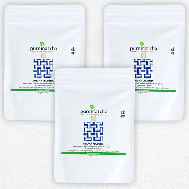 Three packages of purematcha green tea powder on a white background