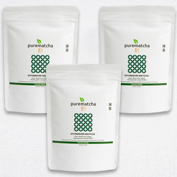 Three packages of KIYOMIDORI purematcha matcha green tea powder on a white background