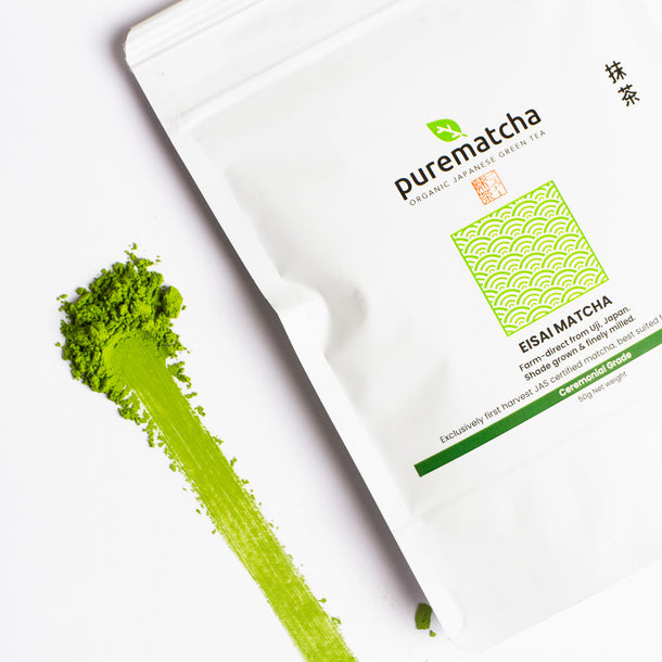White packaging of purematcha green tea powder with green matcha powder on a white background