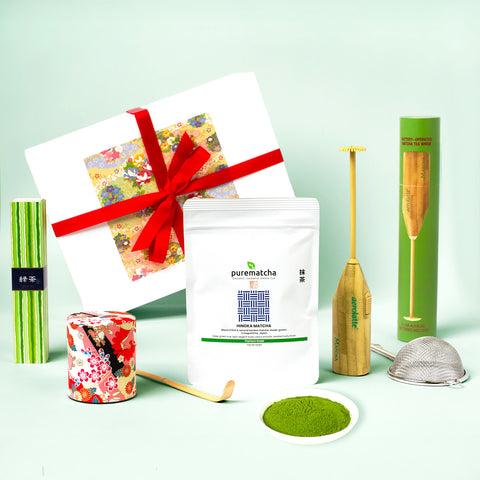 Matcha tea set with packaging and utensils on a light green background