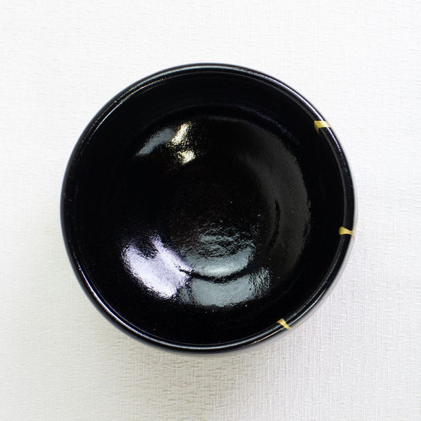 Black ceramic bowl on a light beige background
