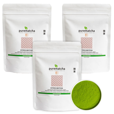 Three packages of purematcha matcha green tea powder with a small scoop of green powder on a white background.