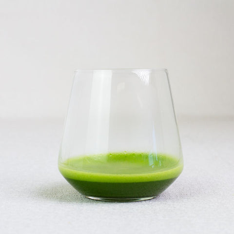 Clear glass with matcha green tea on a white background
