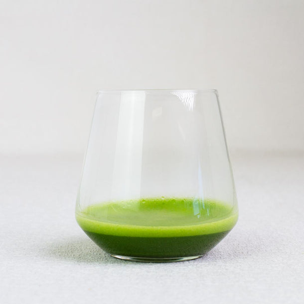 Clear glass with matcha green tea on a white background