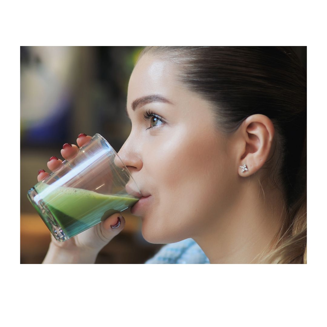 girl sipping matcha from glass