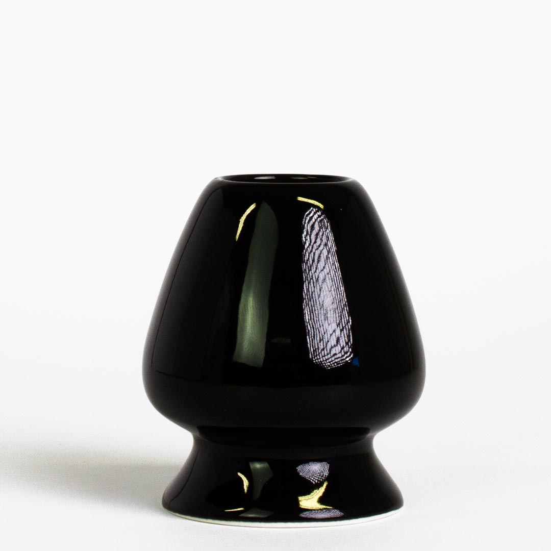 black ceramic matcha tea whisk stand on white background