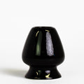 black ceramic matcha tea whisk stand on white background
