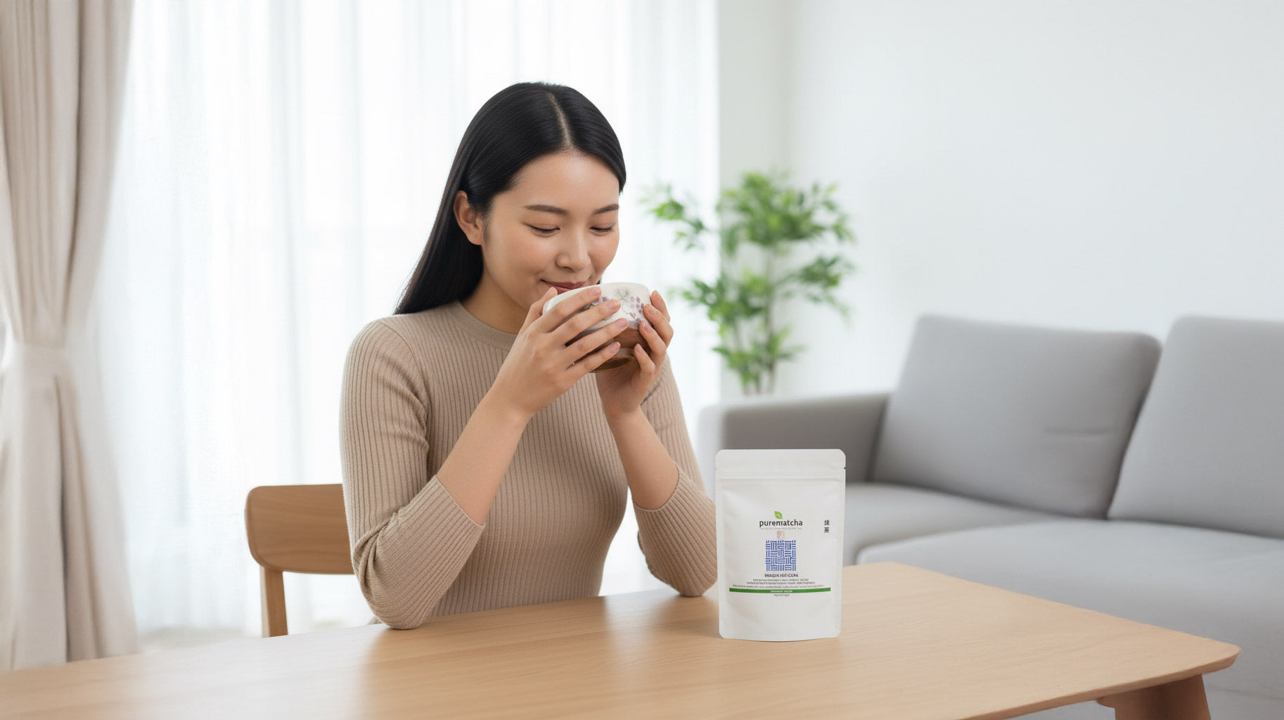 Girl holding a matcha bowl in two hands and about to enjoy bowl of matcha tea.