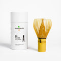 White container labeled 'purematcha' with a yellow whisk on a white background