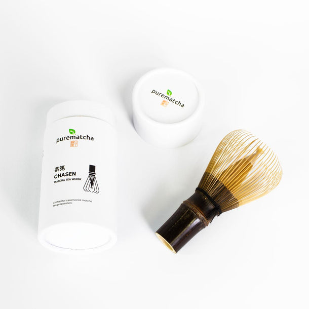 Matcha whisk and containers with 'purematcha' branding on a white background